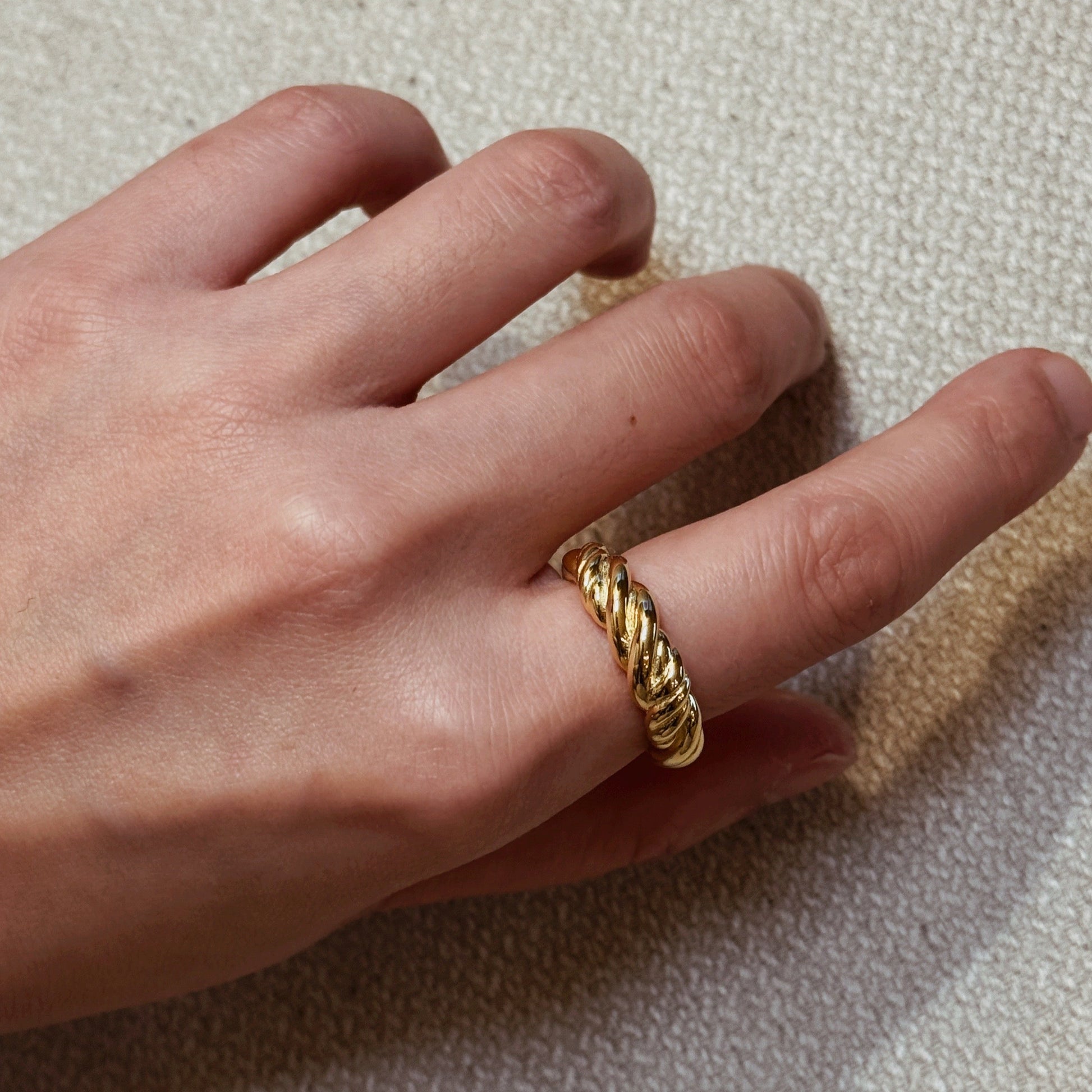 Gold-plated braided ring with a twisted design