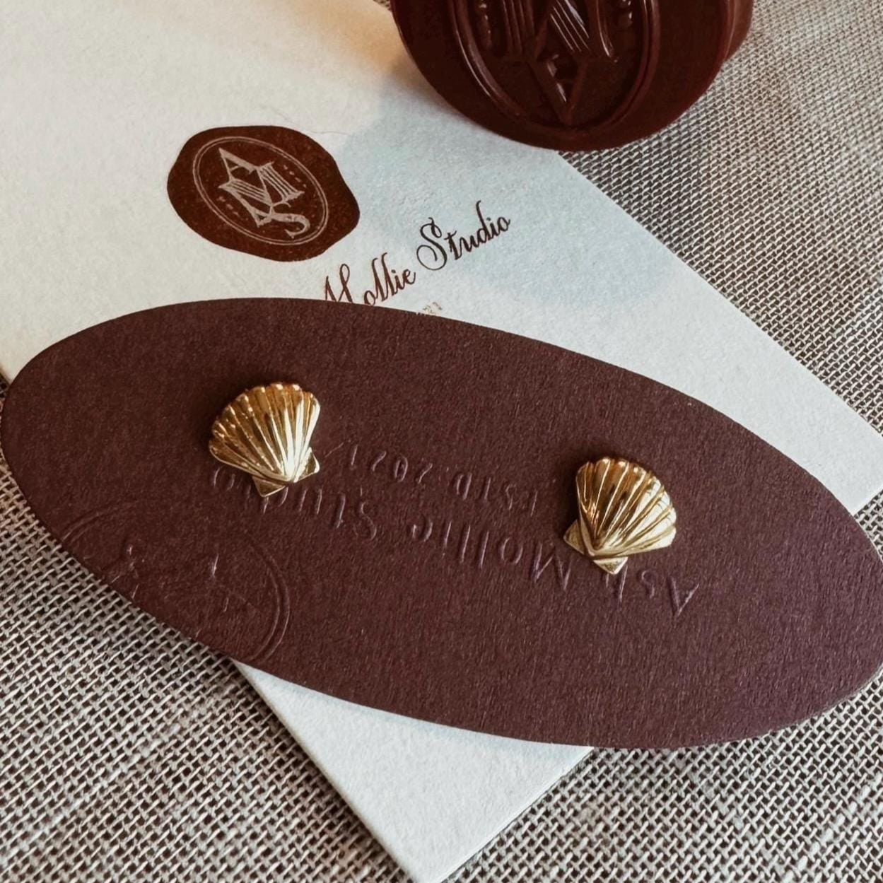 Gold-plated shell earrings with a minimalist design