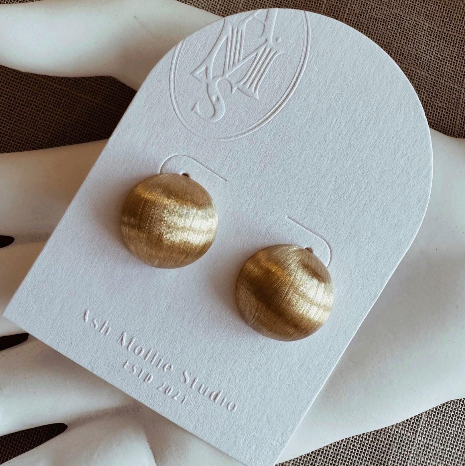 Gold hoop earrings with brushed matte finish