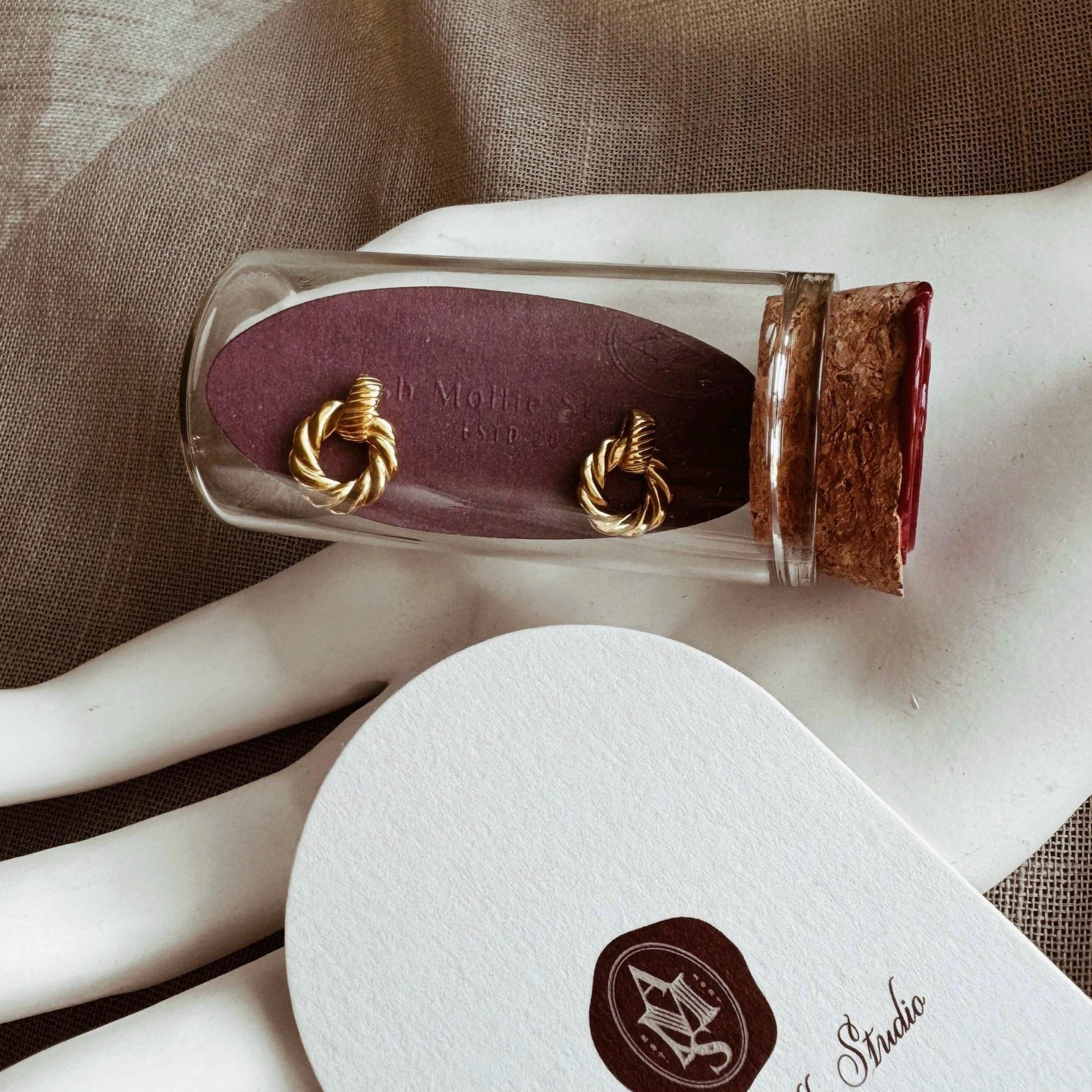 Gold plated small hoop earrings with braided rope design