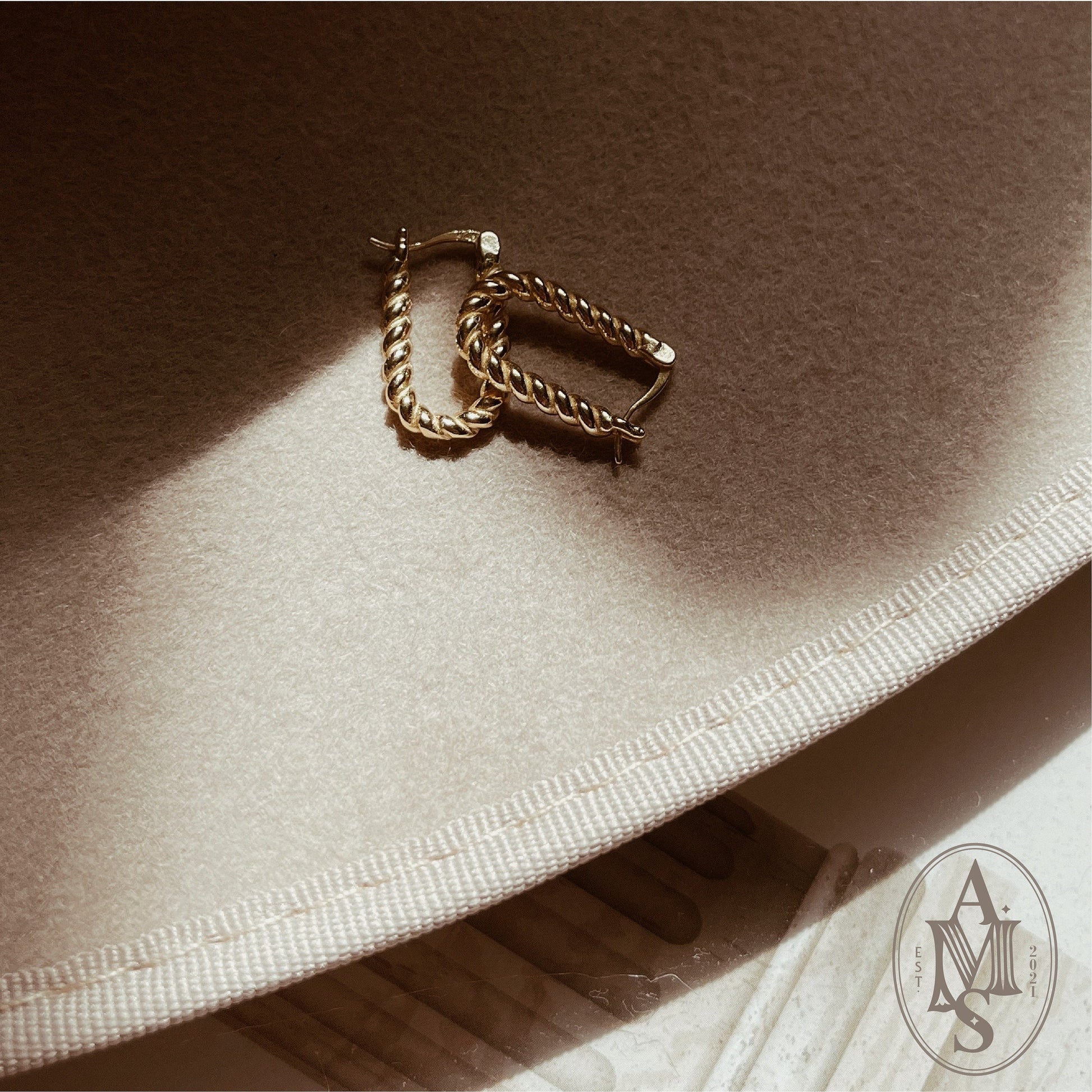 Gold-plated twisted hoop earrings with rope design