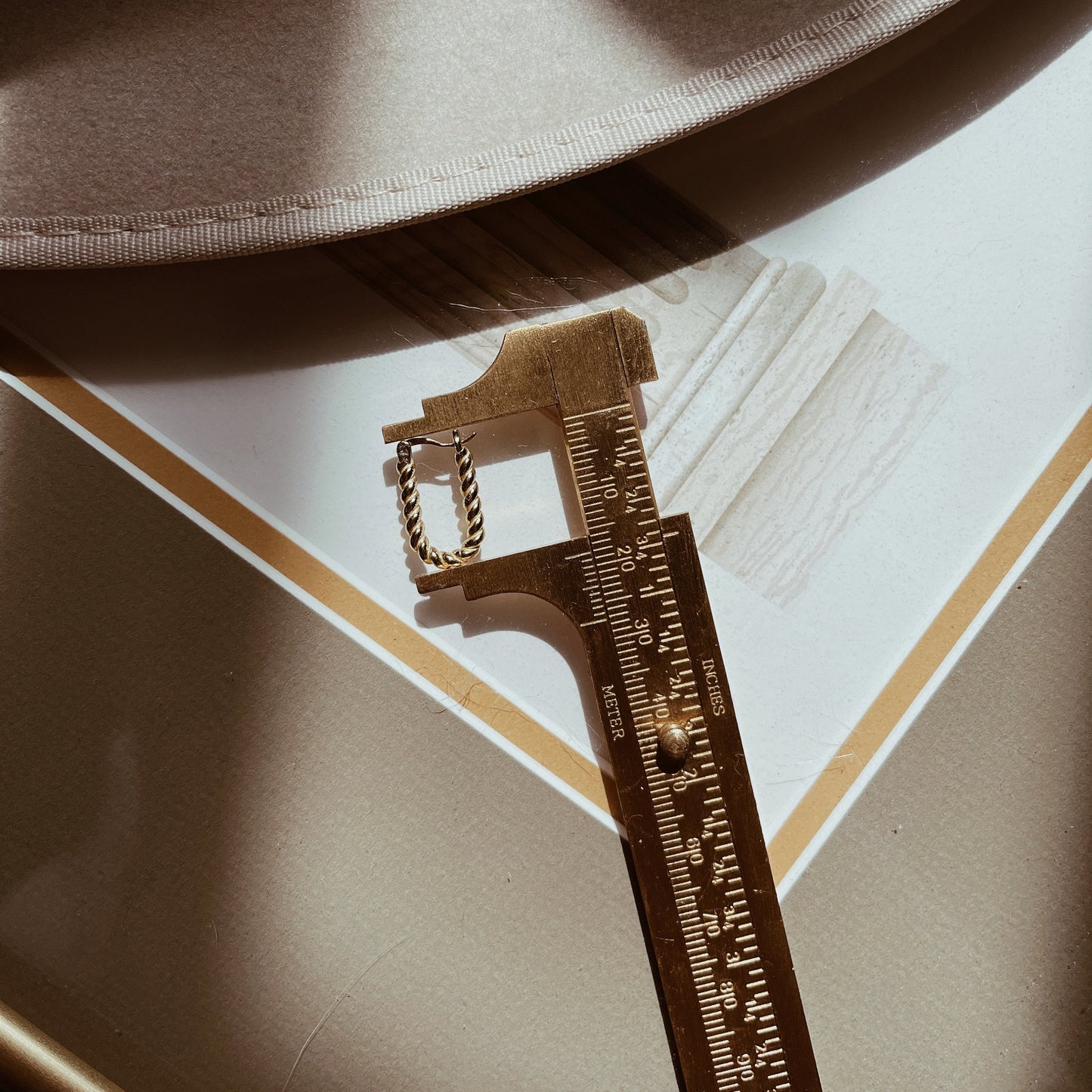 Gold-plated twisted hoop earrings with rope design