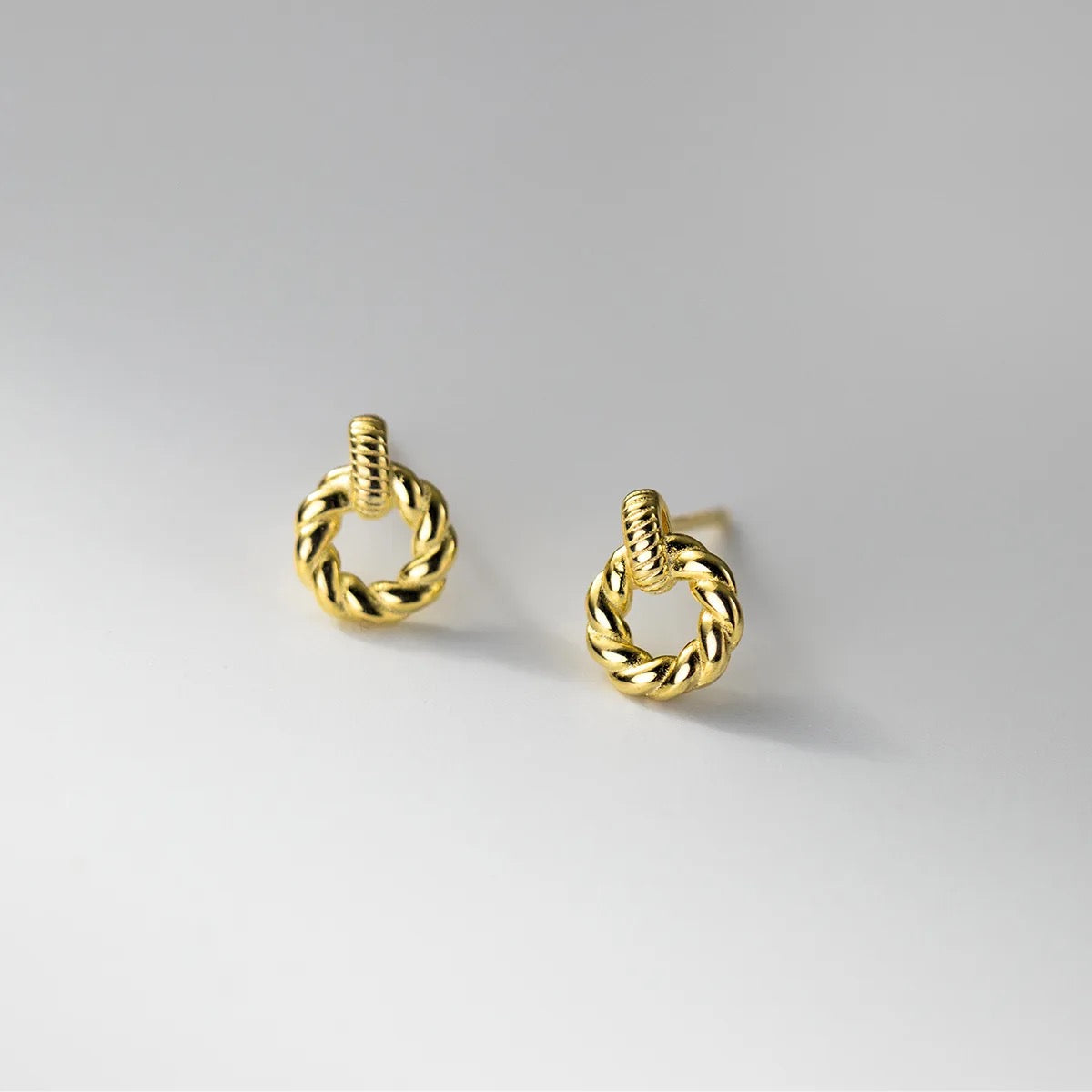 Gold plated small hoop earrings with braided rope design